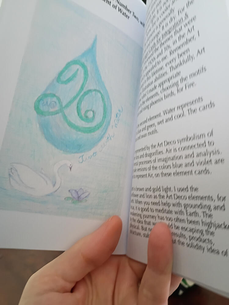 Book opened to image of Two with Water Card