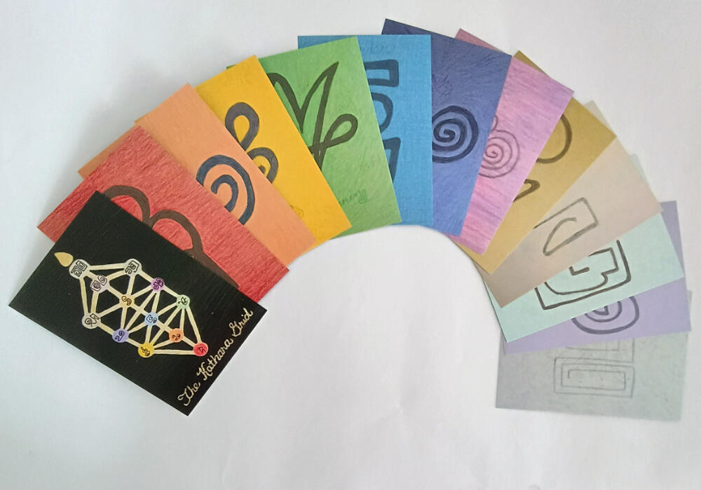 12 dimension light code cards and a card representing the Kathara Grid.